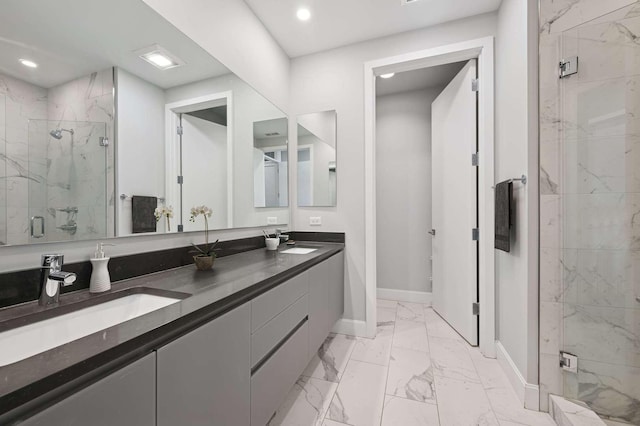 full bathroom featuring baseboards, marble finish floor, a marble finish shower, and a sink