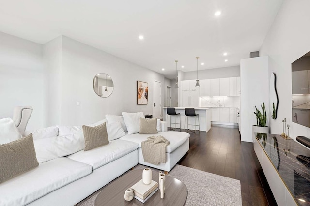 living area with recessed lighting and dark wood-type flooring