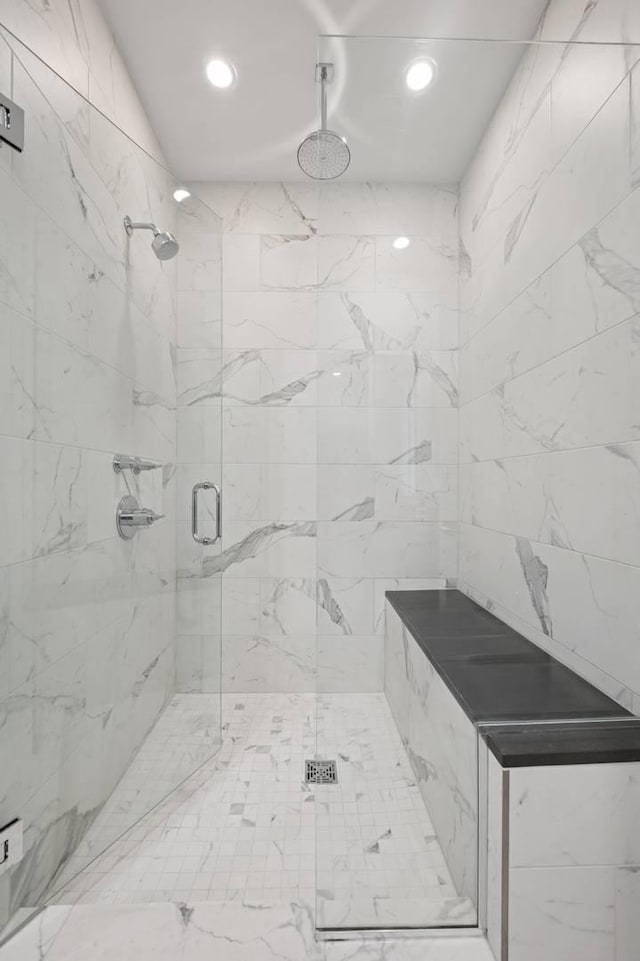 full bathroom featuring a marble finish shower and recessed lighting