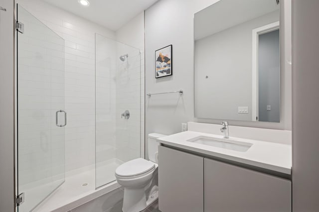 bathroom with vanity, a shower stall, toilet, and recessed lighting