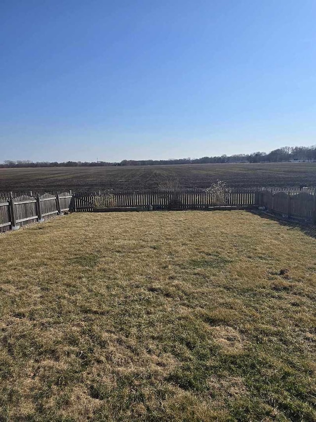 view of yard with a rural view and fence