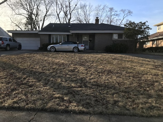 single story home with an attached garage, brick siding, and a chimney