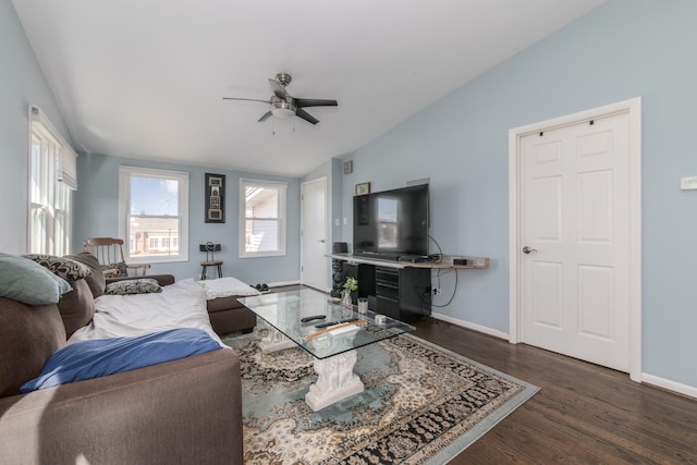 living area with a ceiling fan, lofted ceiling, wood finished floors, and baseboards