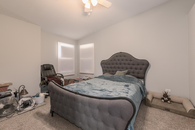 carpeted bedroom featuring a ceiling fan and vaulted ceiling