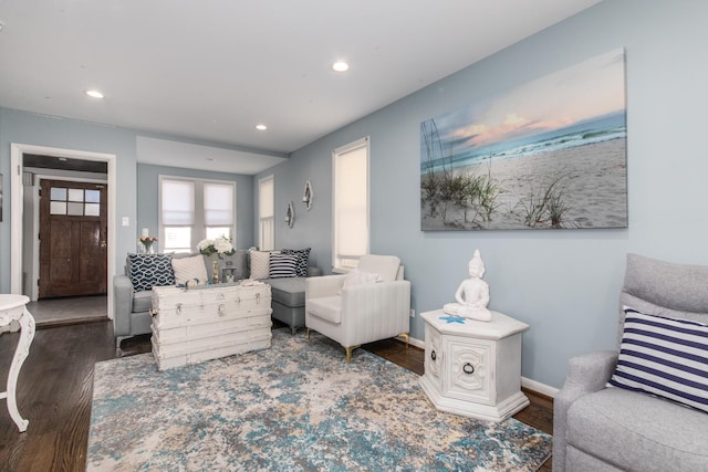 living area with recessed lighting, baseboards, and wood finished floors