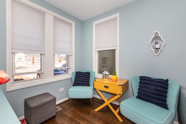 living area with wood finished floors and baseboards