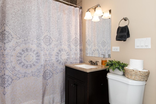 bathroom featuring toilet and vanity