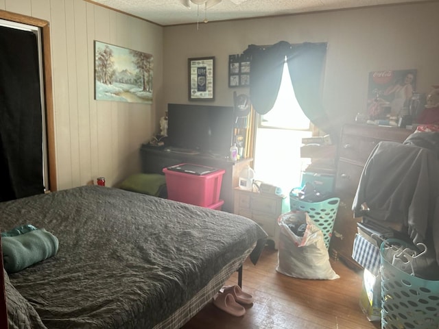 bedroom with wood-type flooring and a textured ceiling