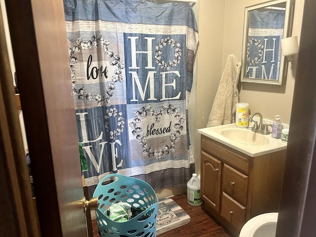 full bathroom featuring vanity, a shower with shower curtain, and wood finished floors