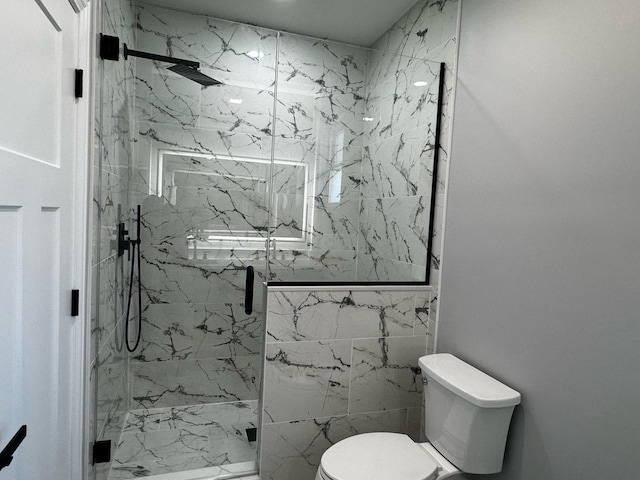 bathroom with a marble finish shower and toilet