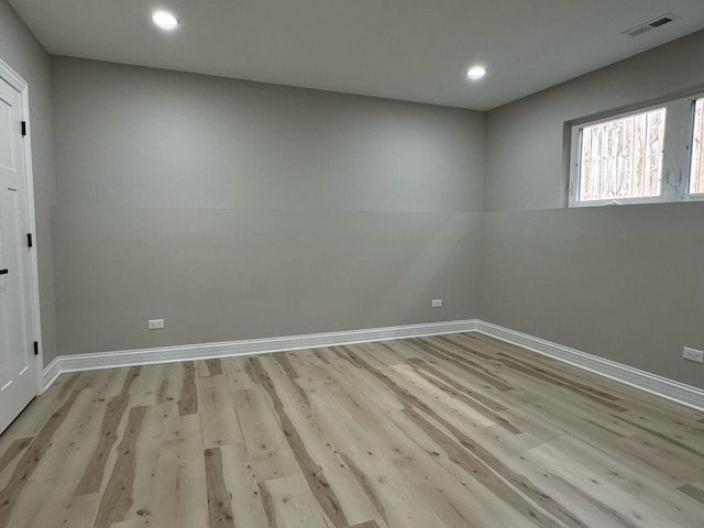 spare room featuring visible vents, light wood-style flooring, and baseboards