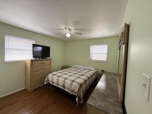 bedroom with a ceiling fan, dark wood-style floors, and baseboards