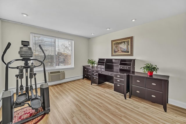 office featuring light wood finished floors, recessed lighting, a wall mounted AC, and baseboards