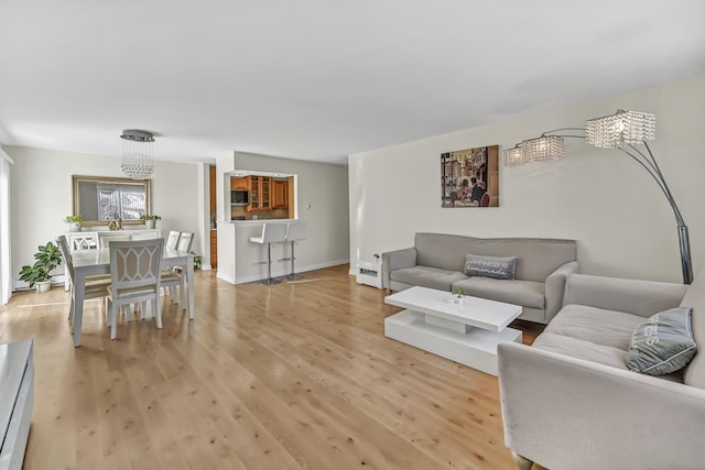 living room featuring light wood-style floors and baseboards