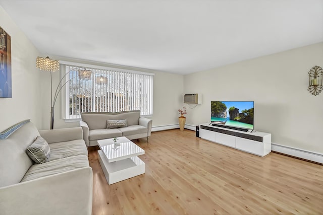 living room with a wall unit AC, wood finished floors, and baseboard heating