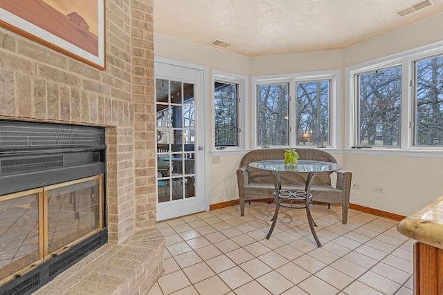 sunroom / solarium with a fireplace and visible vents