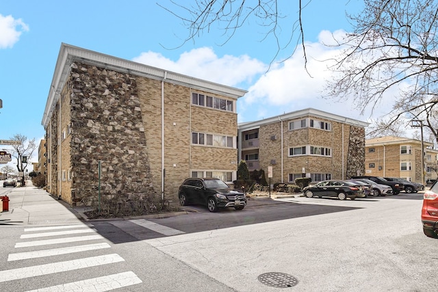 view of property featuring uncovered parking