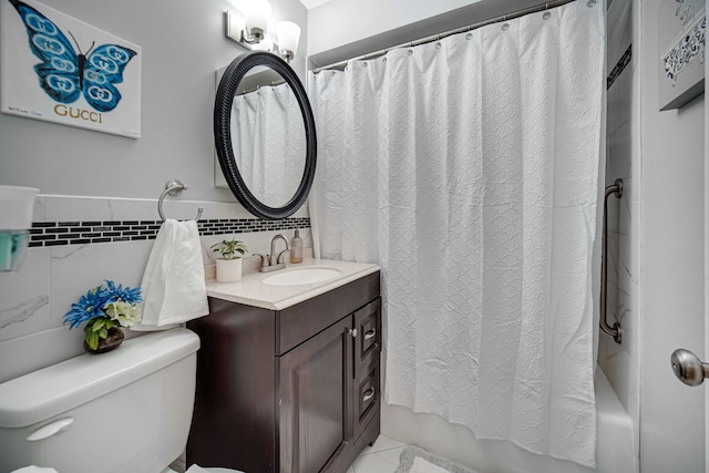 full bath featuring vanity, tile walls, toilet, and shower / tub combo with curtain