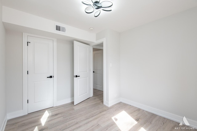 unfurnished bedroom featuring visible vents, baseboards, and light wood-style floors