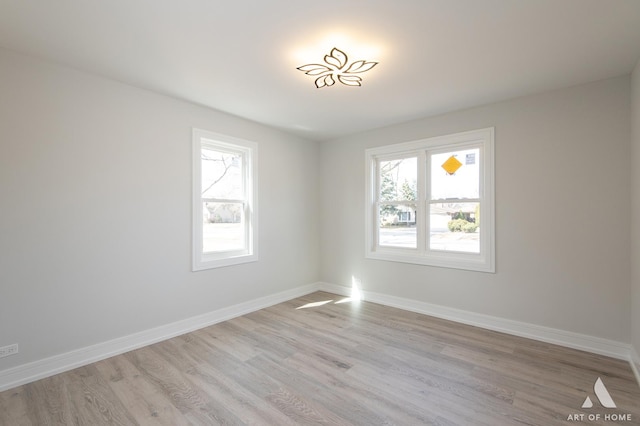 empty room featuring light wood-style floors and baseboards