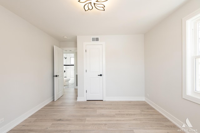 interior space with visible vents, baseboards, and light wood-style floors