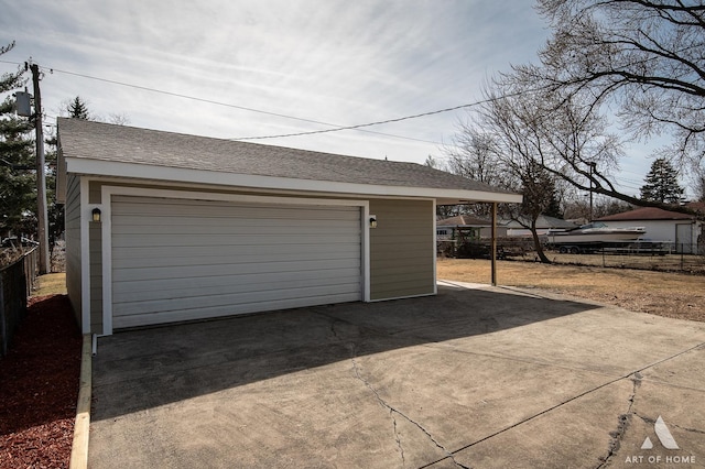 detached garage featuring fence