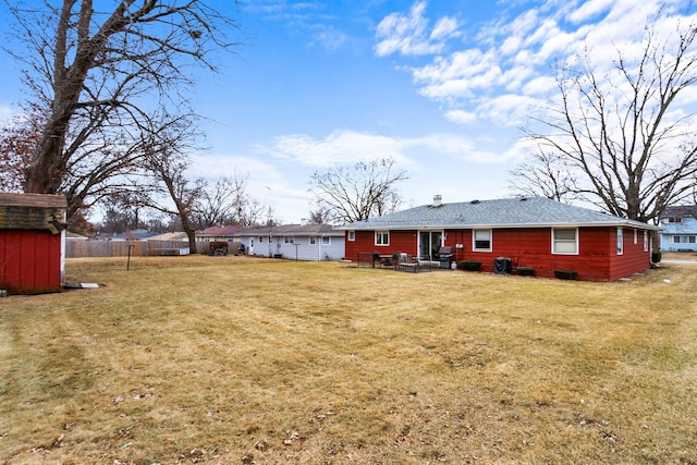 rear view of property featuring a yard