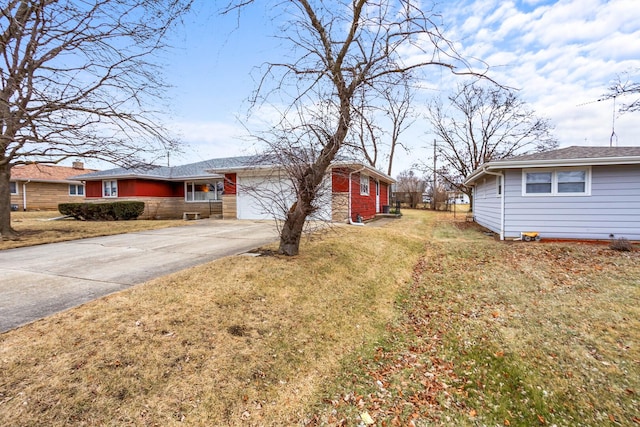 exterior space featuring a garage, a yard, and concrete driveway