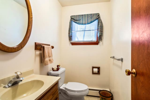 bathroom featuring baseboard heating, toilet, and vanity