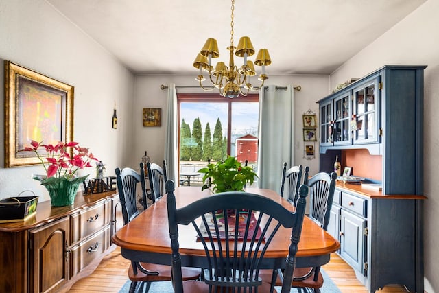 dining space with a chandelier and light wood finished floors