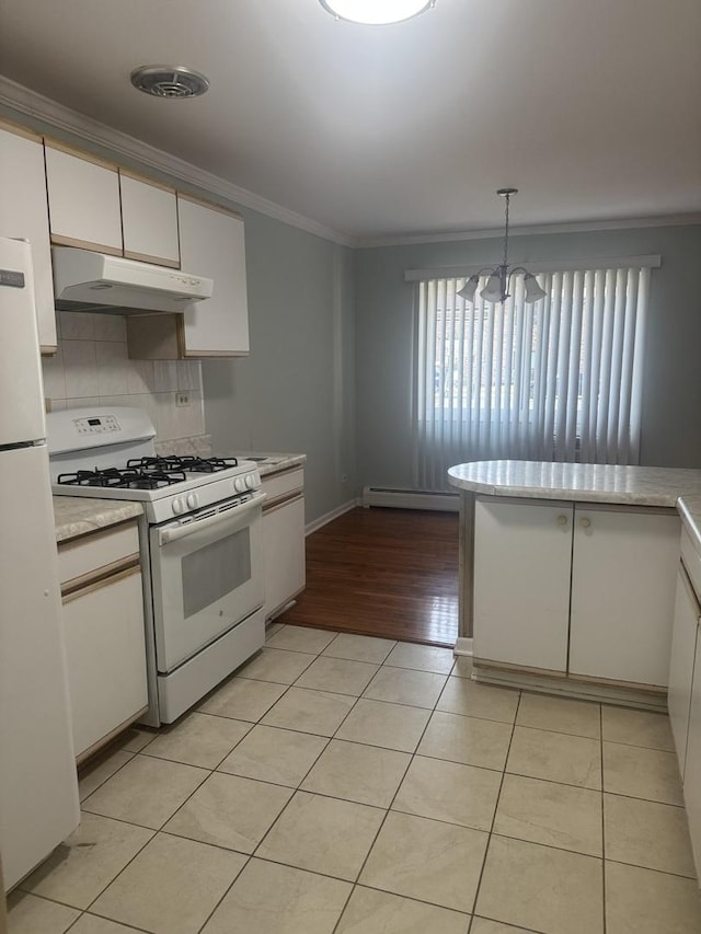 kitchen featuring under cabinet range hood, white appliances, light tile patterned flooring, and ornamental molding