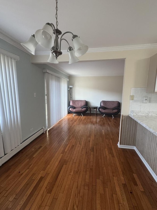 unfurnished room featuring dark wood finished floors, a baseboard radiator, a chandelier, and ornamental molding