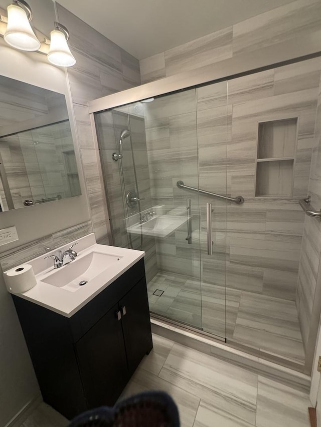 full bathroom with vanity and a stall shower