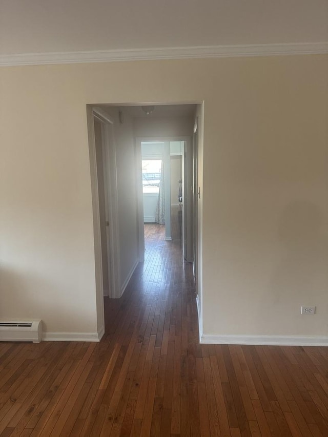 hall featuring dark wood finished floors, crown molding, baseboards, and baseboard heating