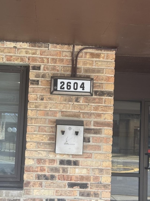 exterior details featuring brick siding