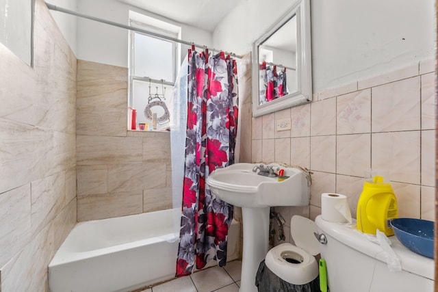 bathroom with tile patterned floors, toilet, tile walls, and shower / tub combo with curtain