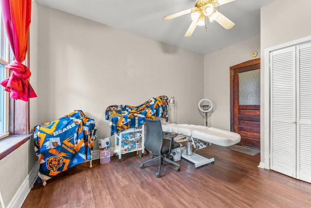 interior space featuring baseboards, ceiling fan, and wood finished floors