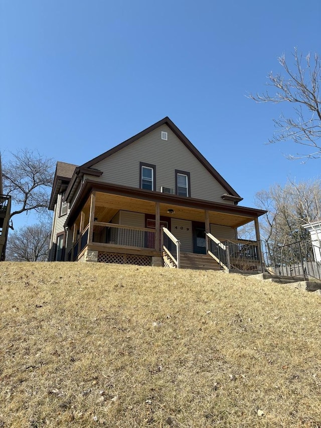 back of house featuring covered porch