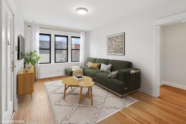 living room with light wood-type flooring and baseboards