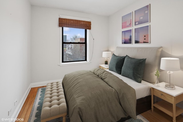 bedroom with wood finished floors and baseboards