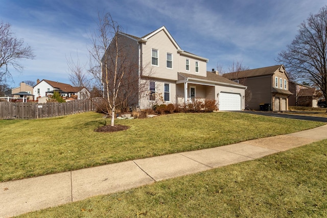 view of front of property with driveway, a front lawn, an attached garage, and fence