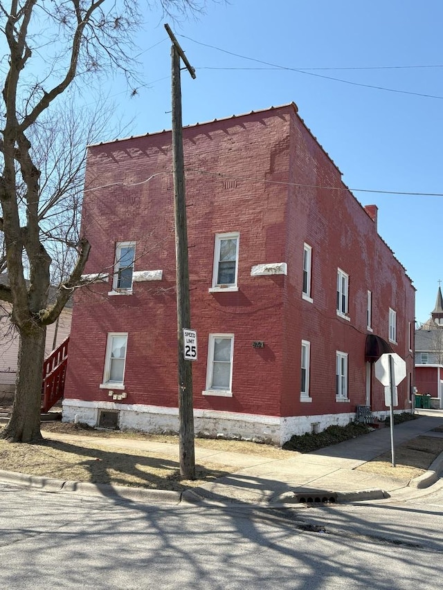 view of side of property with brick siding