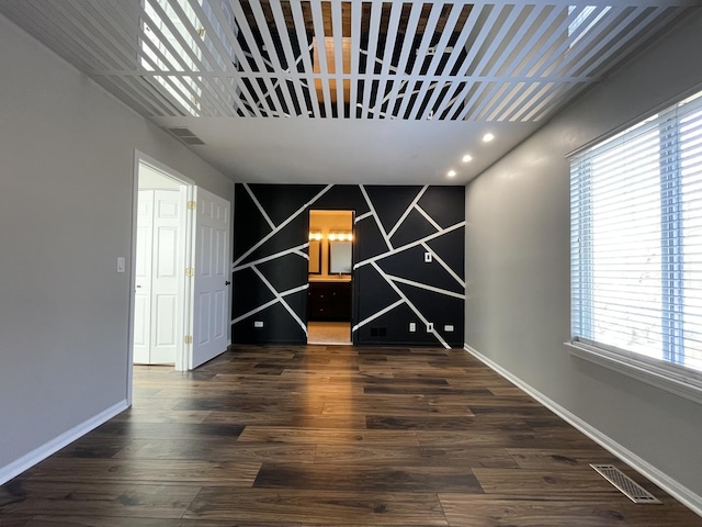 unfurnished dining area featuring visible vents, recessed lighting, baseboards, and wood finished floors