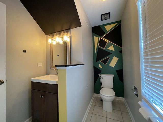 bathroom featuring tile patterned floors, baseboards, toilet, and vanity