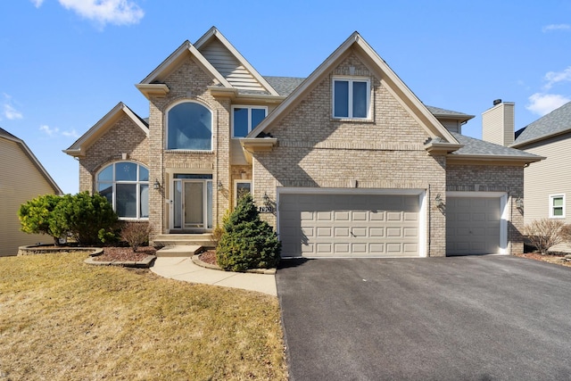 view of front of house with aphalt driveway, brick siding, roof with shingles, and a front lawn