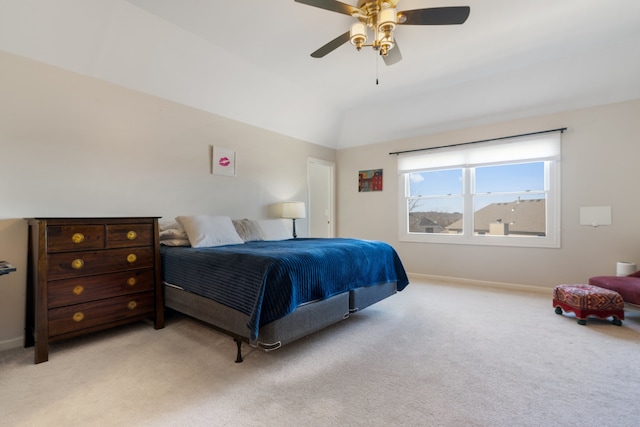 bedroom featuring light colored carpet, baseboards, lofted ceiling, and ceiling fan