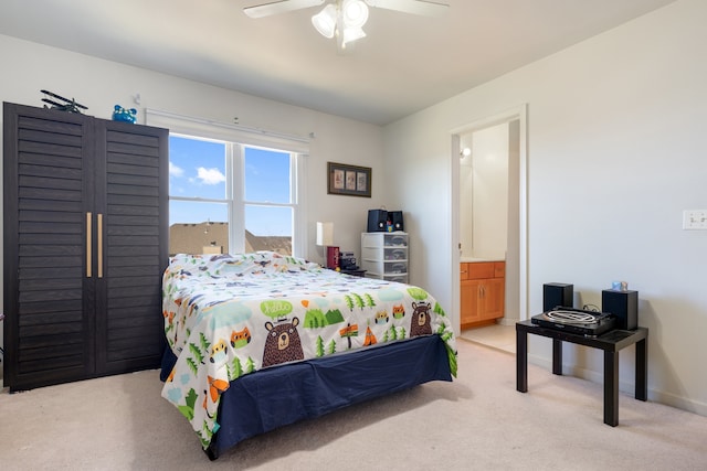 bedroom featuring ensuite bathroom, a ceiling fan, baseboards, and carpet floors