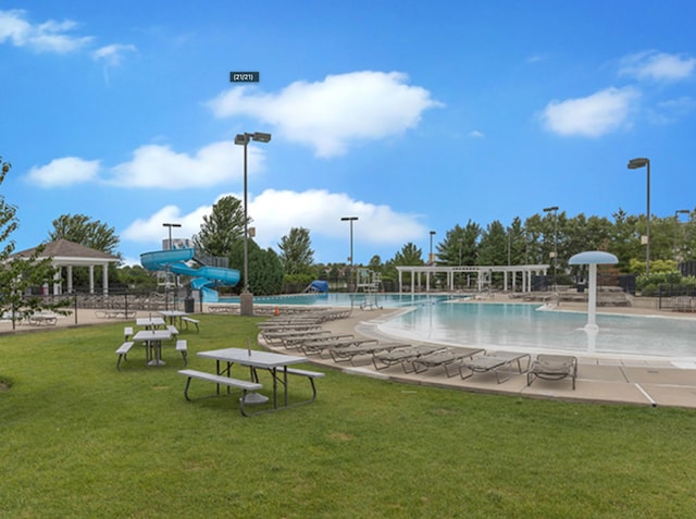 pool with a gazebo, a patio, a water slide, and a yard