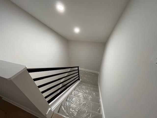 stairway featuring recessed lighting and baseboards