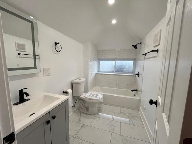 bathroom with baseboards, toilet, shower / bathing tub combination, vanity, and marble finish floor